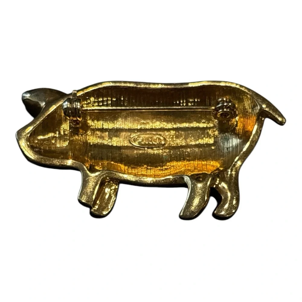 Ciro stamped pink rhinestone pig w/green eye set in gold tone. Circa 1980’s JB4